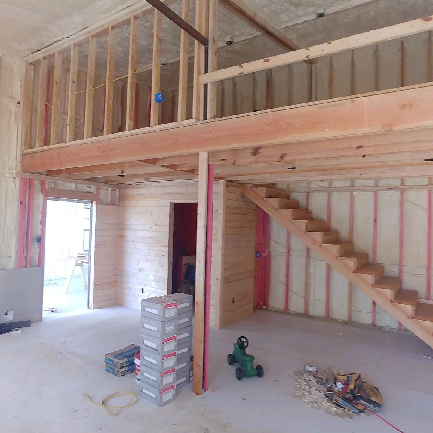 Custom loft framing and open staircase under construction